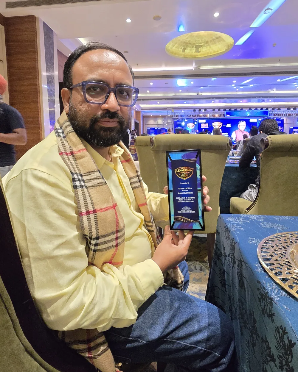 Gitish Chopra holding the Times Leadership Summit and Icons 2026 trophy